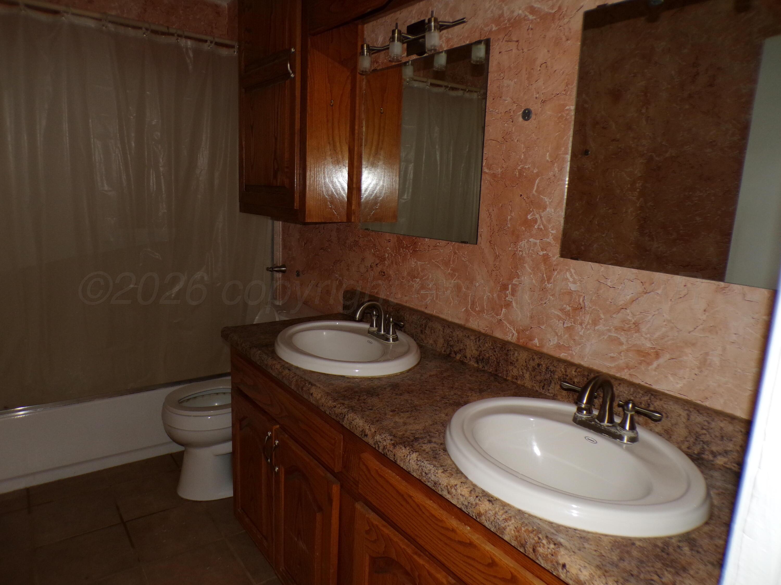 403 North Robey Avenue Fritch, TX 79036 - Photo 18 of 24 a bathroom with a sink and a toilet