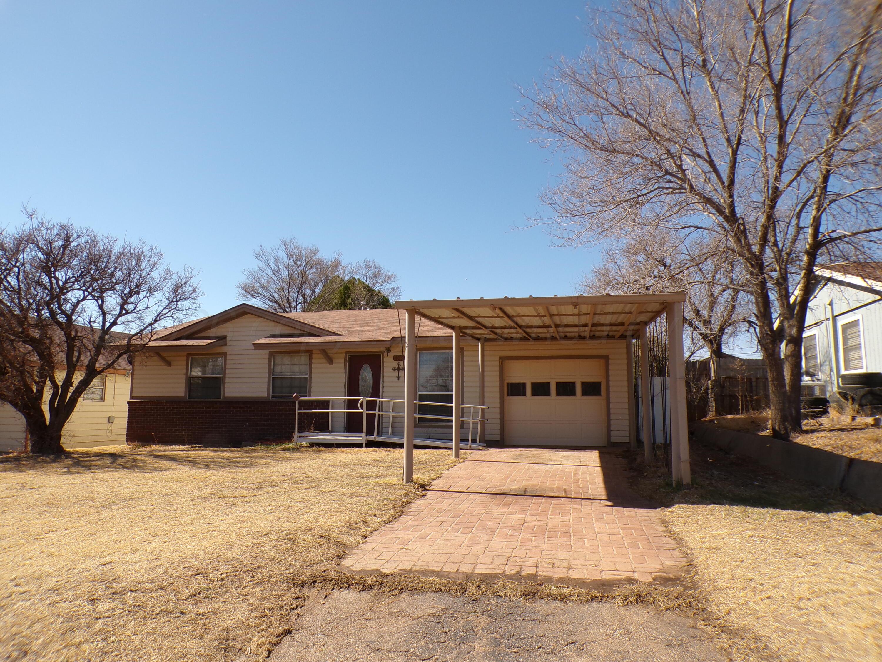 403 North Robey Avenue Fritch, TX 79036 - Photo 2 of 24 a front view of a house with a yard covered in snow
