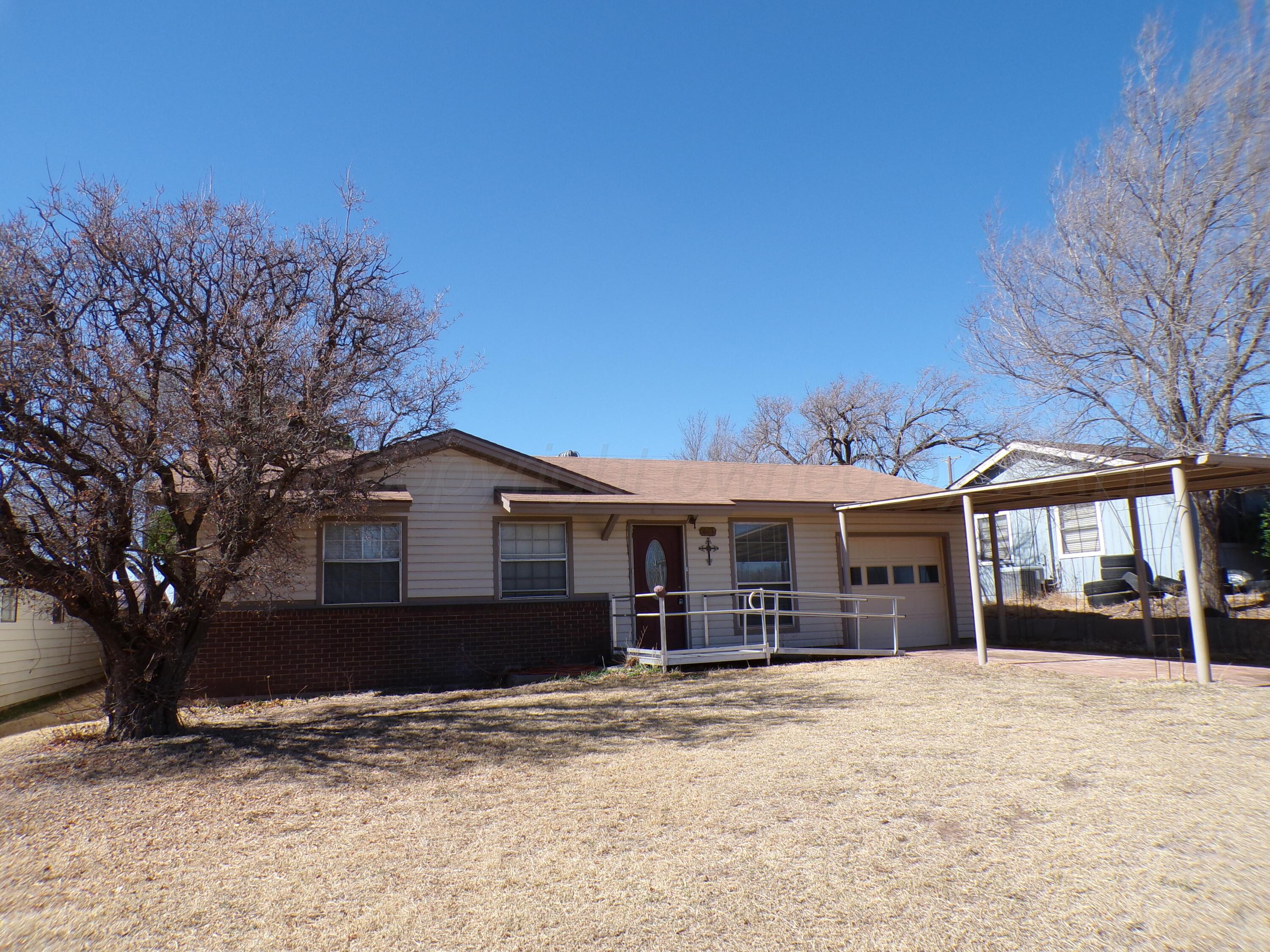 403 North Robey Avenue Fritch, TX 79036 - Photo 3 of 24 a front view of a house with a yard covered with snow in front of house
