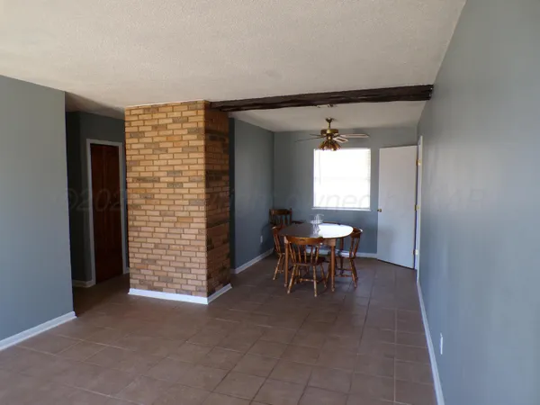 a view of a livingroom with a chair and dining table