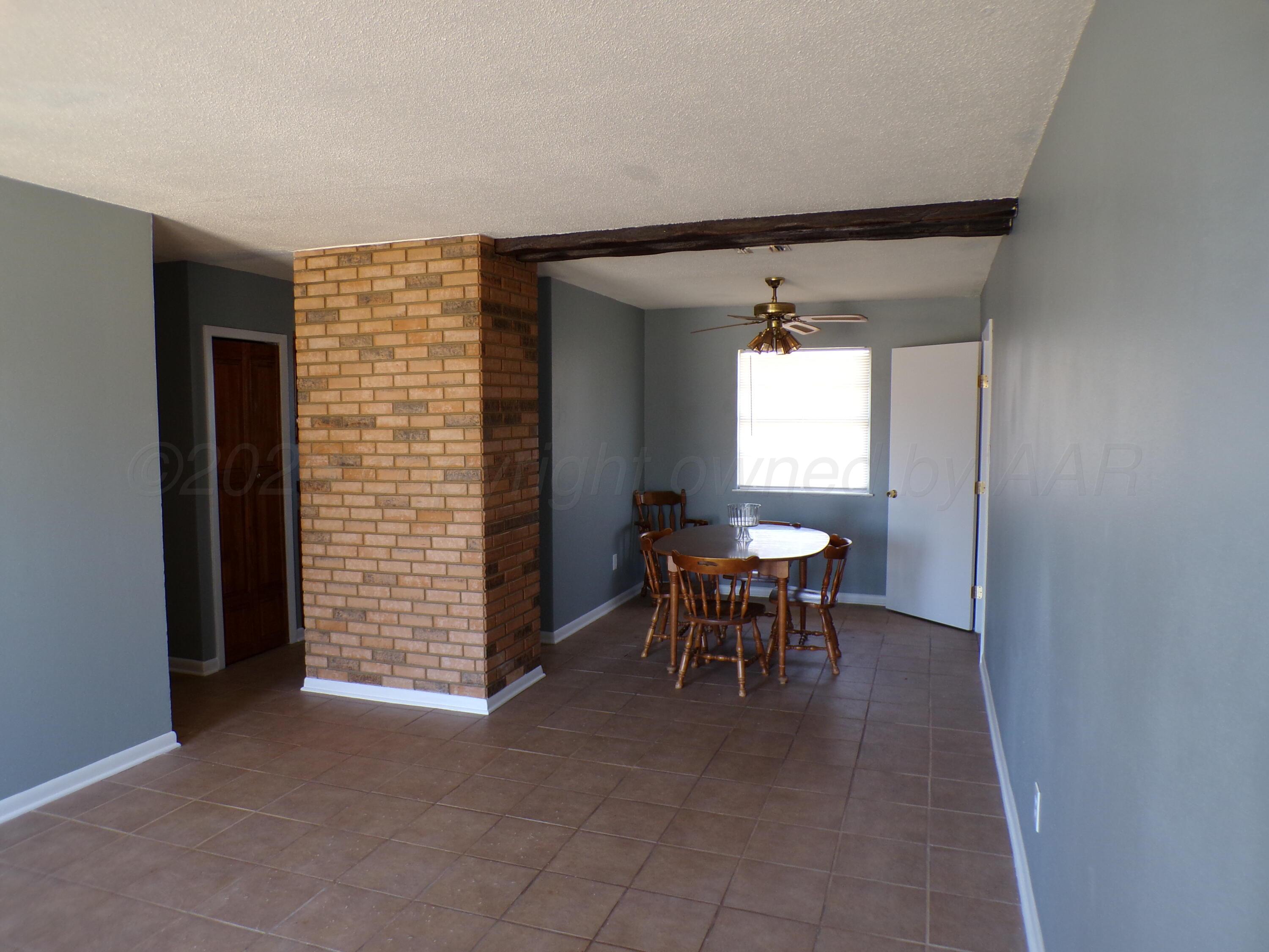 403 North Robey Avenue Fritch, TX 79036 - Photo 7 of 24 a view of a livingroom with a chair and dining table