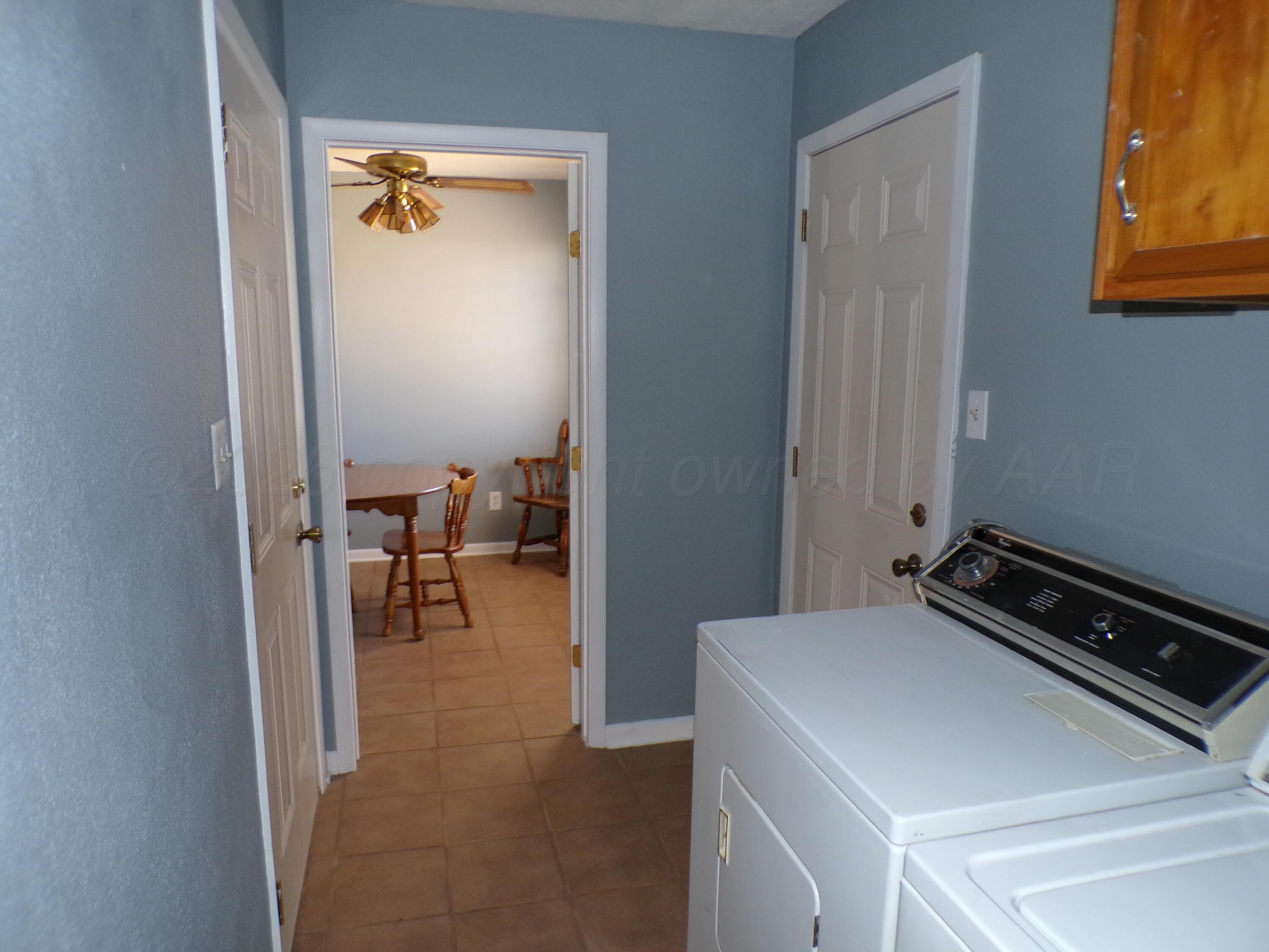 403 North Robey Avenue Fritch, TX 79036 - Photo 9 of 24 a view of a room that has a bed and a chair in it