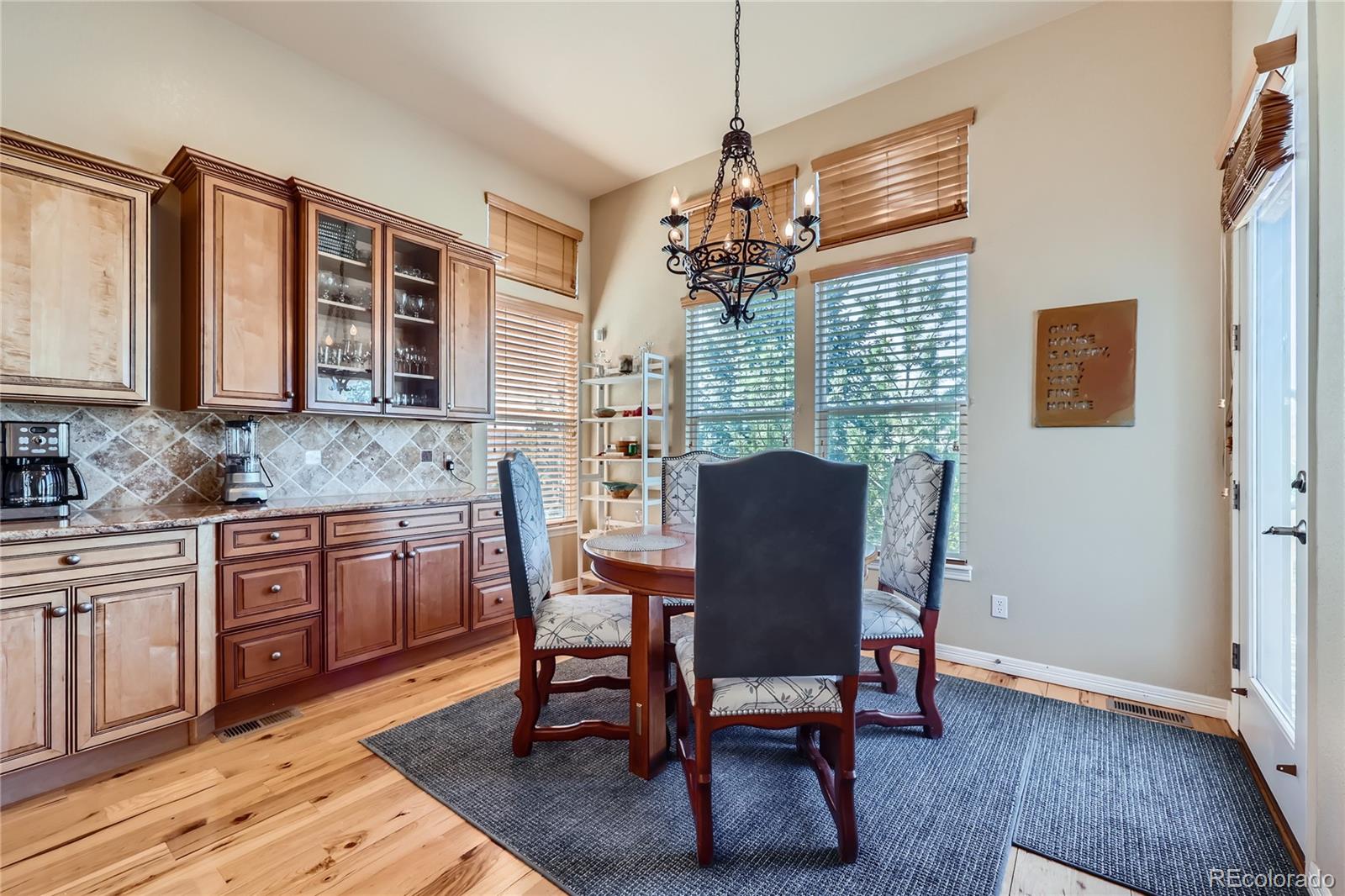 7009 Winter Ridge Place Castle Pines, CO 80108 - Photo 12 of 42 a view of a dining room with furniture window and wooden floor