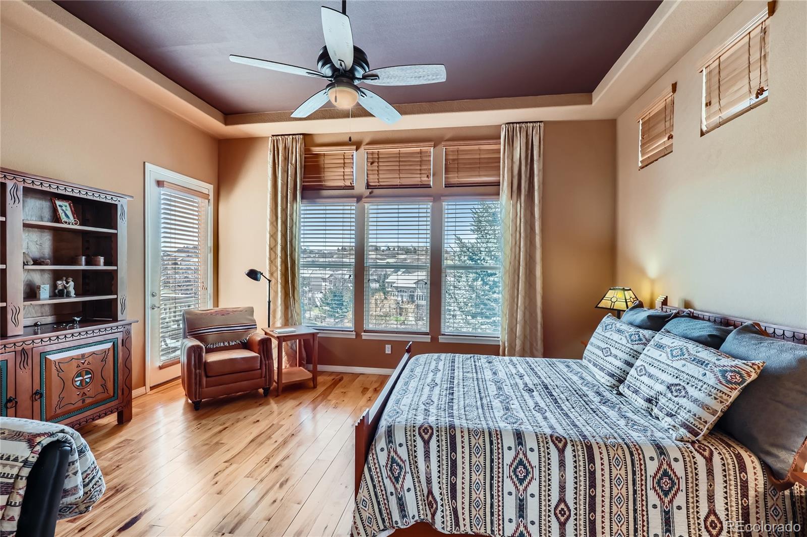 7009 Winter Ridge Place Castle Pines, CO 80108 - Photo 16 of 42 a bedroom with a bed couch and a window