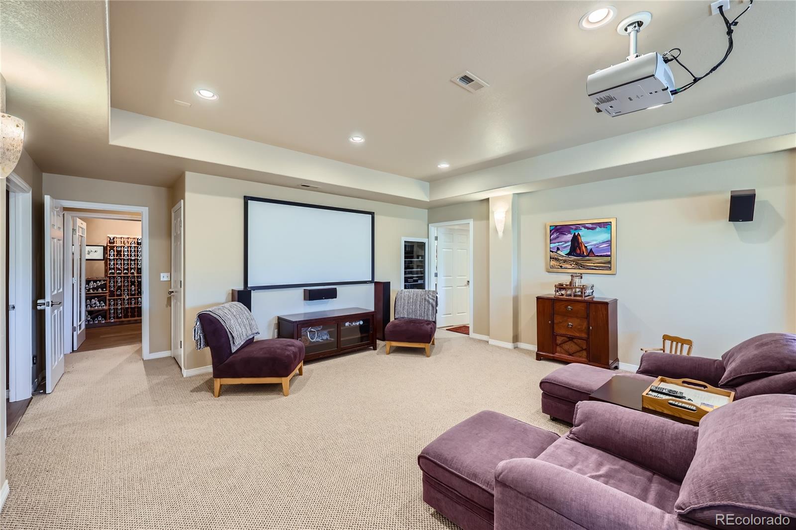 7009 Winter Ridge Place Castle Pines, CO 80108 - Photo 25 of 42 a living room with furniture a fireplace and a flat screen tv