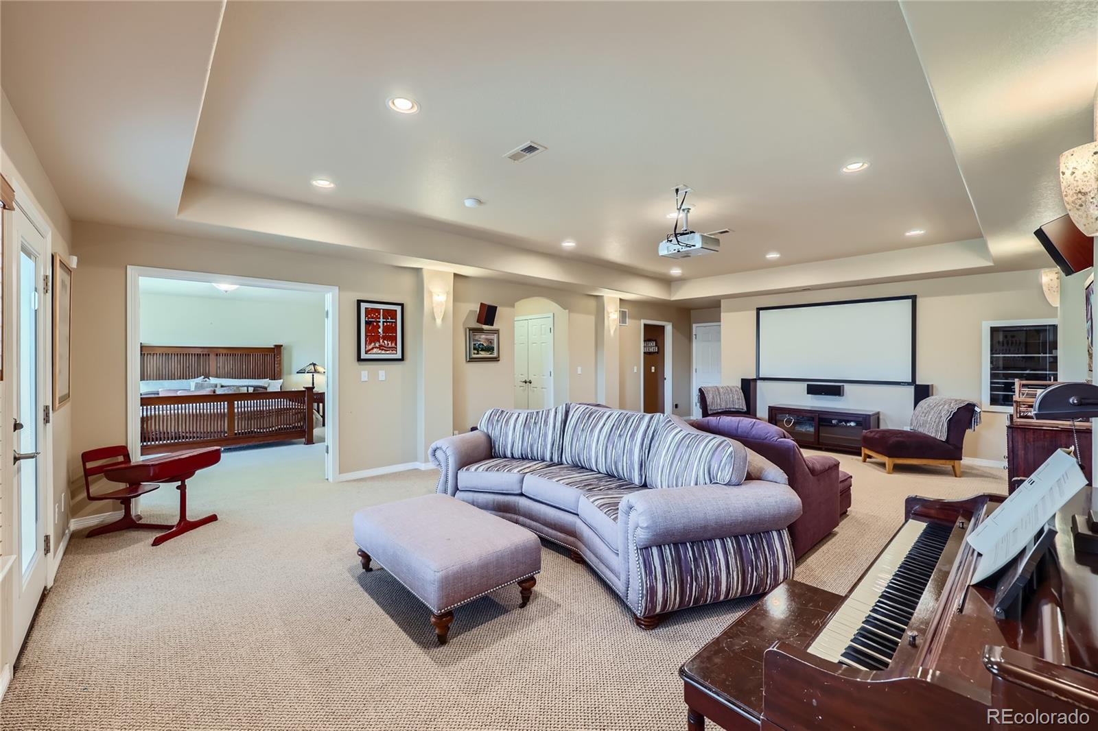 7009 Winter Ridge Place Castle Pines, CO 80108 - Photo 28 of 42 a living room with furniture and a flat screen tv