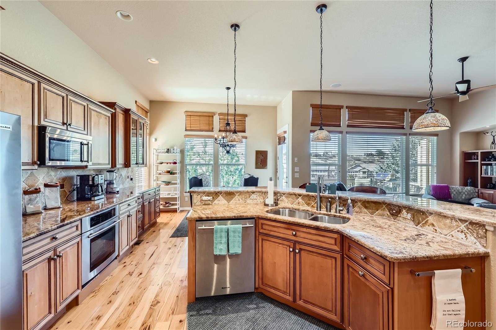 7009 Winter Ridge Place Castle Pines, CO 80108 - Photo 8 of 42 a kitchen with stainless steel appliances granite countertop a stove a sink and a refrigerator