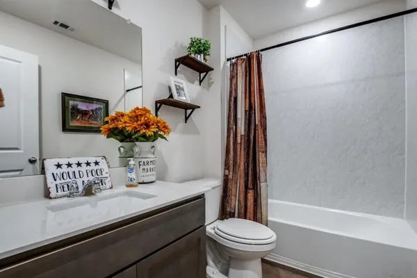 a spacious bathroom with a shower sink and mirror