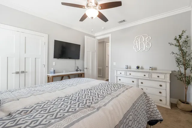 a bedroom with a bed and a painting on the wall