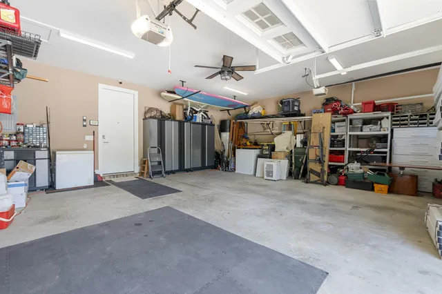 a living room with furniture potted plant and a large window