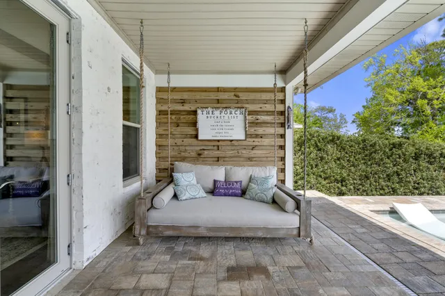 a backyard of a house with table and chairs