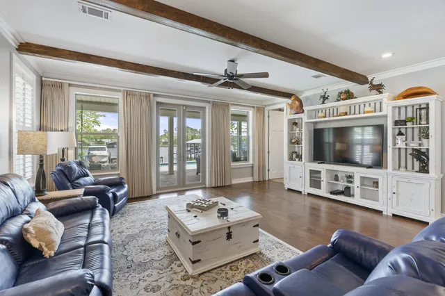 a living room with furniture or wooden floor and a large window