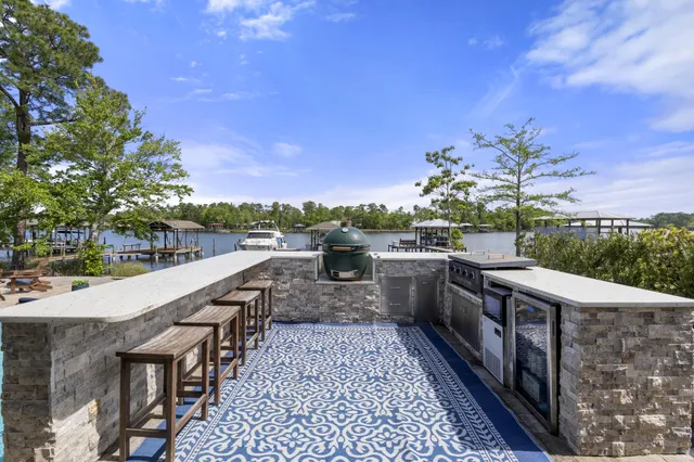 a view of a patio with couches table and chairs and potted plants