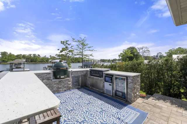a view of a patio with table and chairs with wooden floor and fence