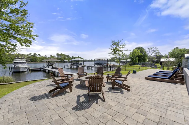 a body of water with a tree in the background