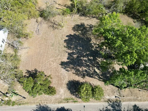an aerial view of a houses with yard