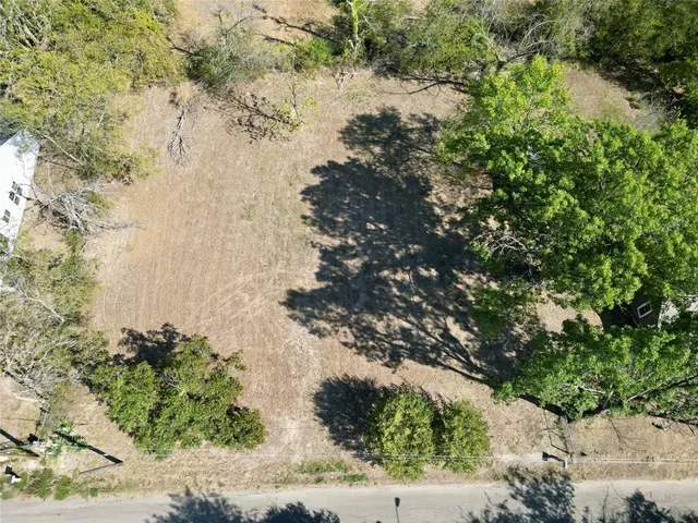 an aerial view of a houses with yard