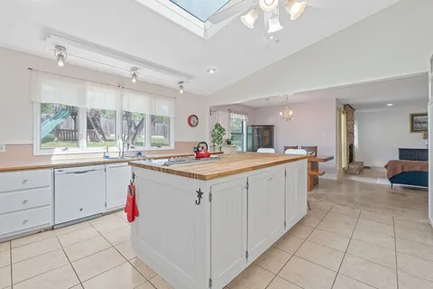 a large white kitchen with a large window