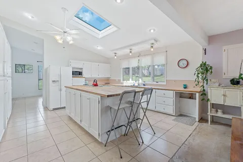 a kitchen with cabinets and chairs