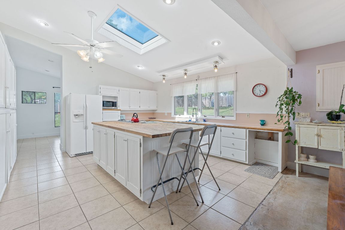 8705 South View Road Austin, TX 78737 - Photo 11 of 39 a kitchen with cabinets and chairs