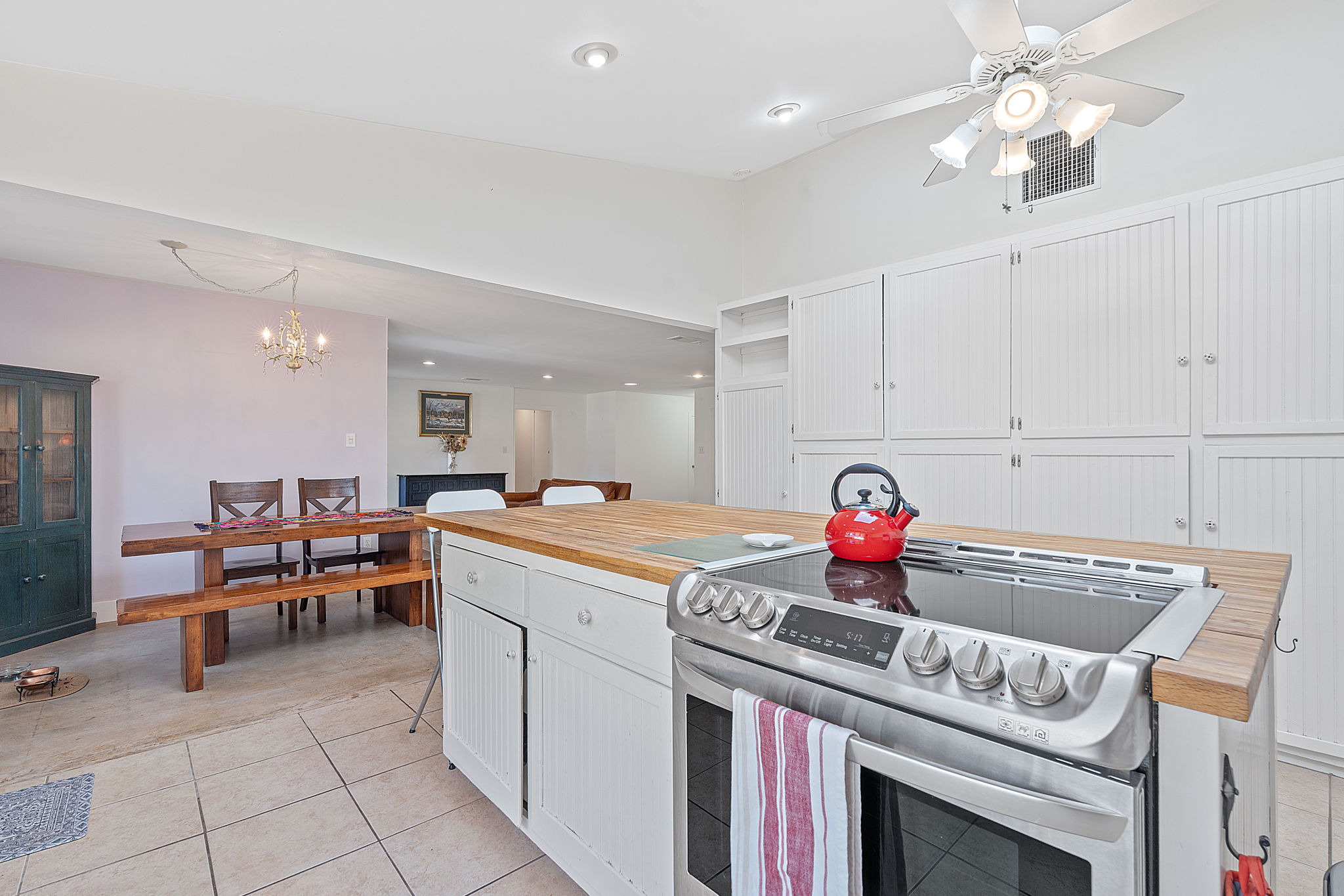 8705 South View Road Austin, TX 78737 - Photo 13 of 39 Kitchen Island with Modern Electric Range and View to Dining Area with Abundant Storage