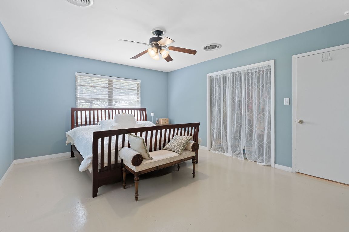 8705 South View Road Austin, TX 78737 - Photo 15 of 39 a bedroom with furniture and a window