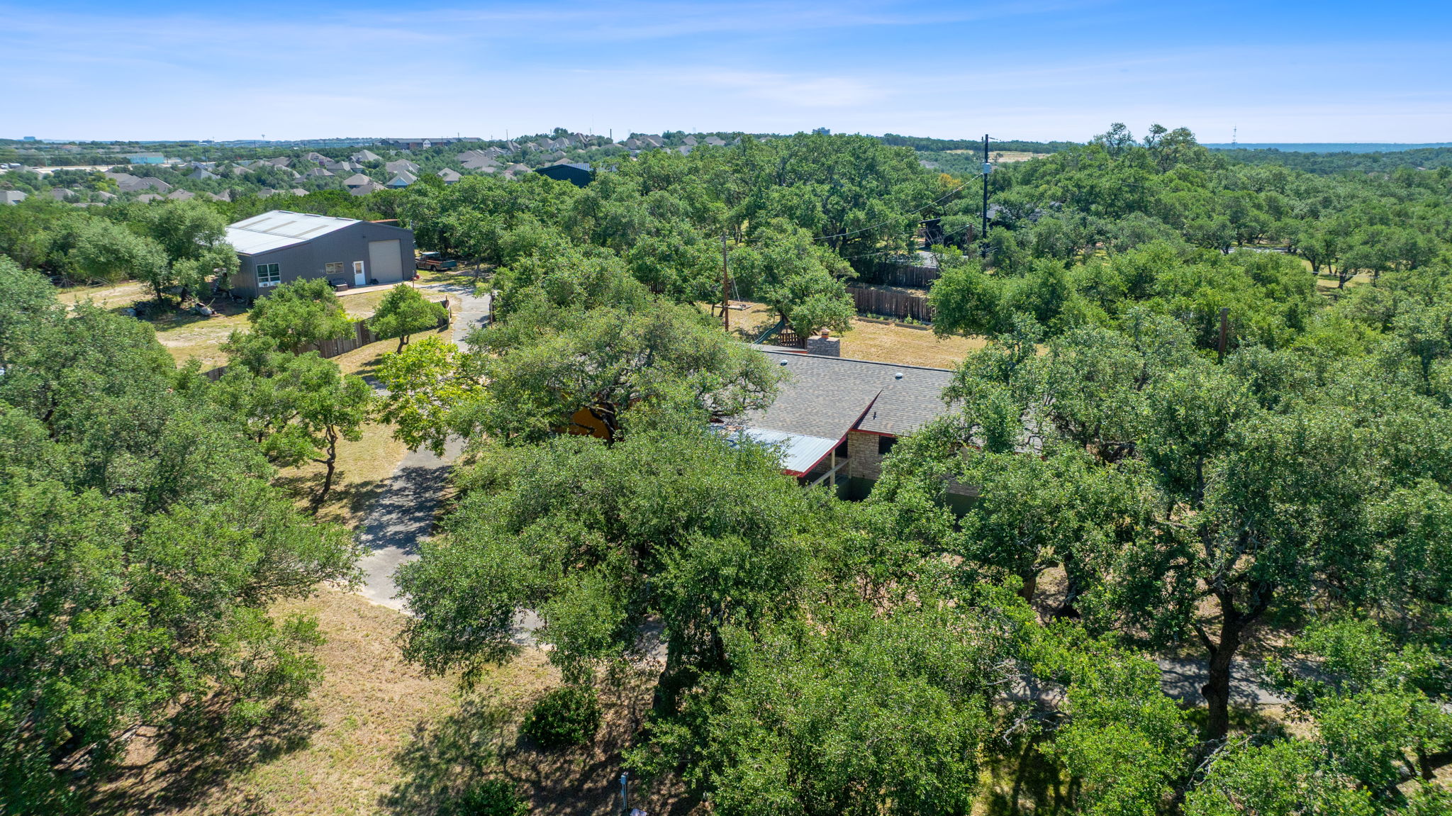 8705 South View Road Austin, TX 78737 - Photo 2 of 39 Secluded Hill Country Retreat on Wooded Acreage with Mature Oak Trees. Property features main home and detached workshop/studio surrounded by natural Texas landscape with expansive views.