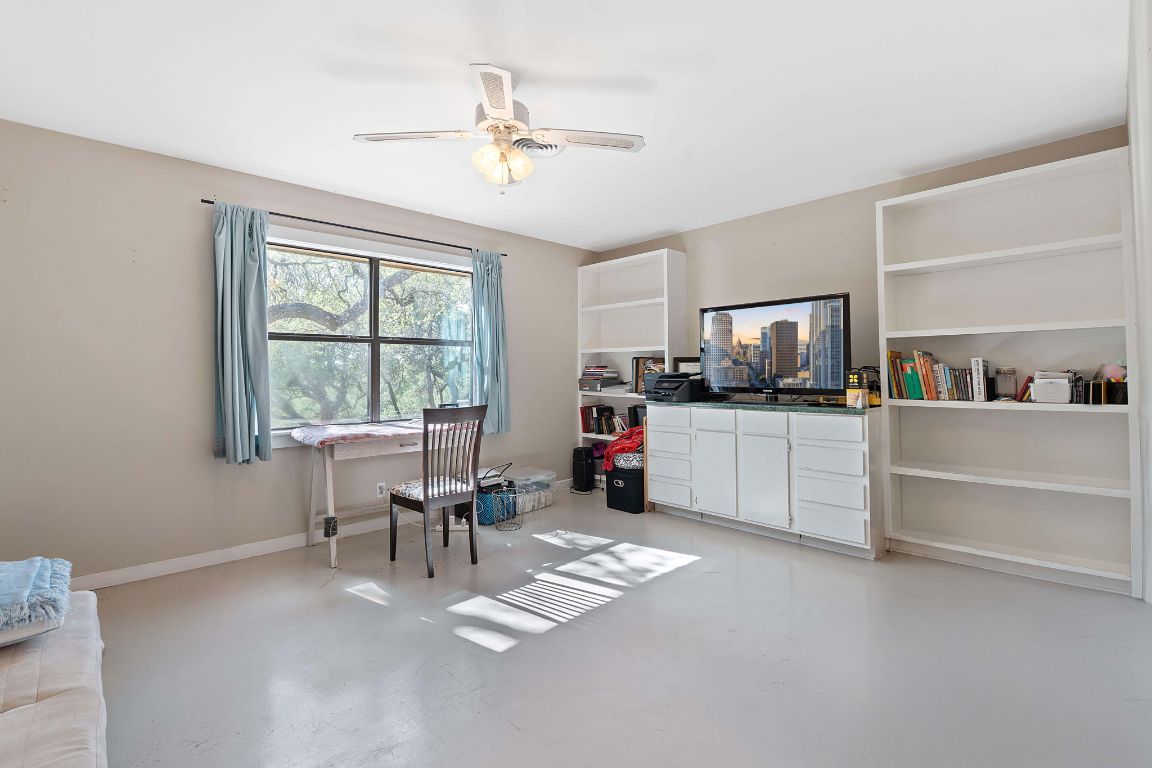 8705 South View Road Austin, TX 78737 - Photo 24 of 39 a view of a workspace with furniture and a window