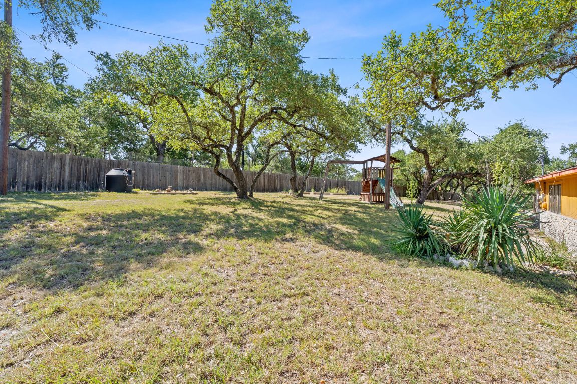 8705 South View Road Austin, TX 78737 - Photo 30 of 39 a view of a backyard with trees