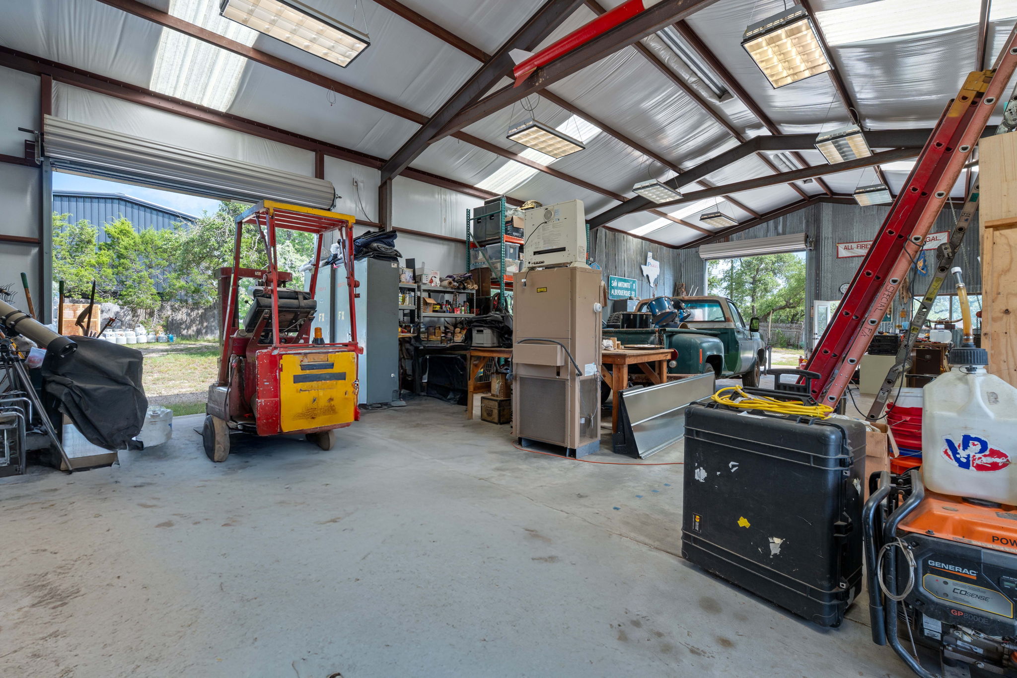 8705 South View Road Austin, TX 78737 - Photo 34 of 39 Open Workshop. With 14’ Walls and a 12’ Overhead Door, this is a Versatile space for any need, including RV Storage and a dedicated Loading Dock.
