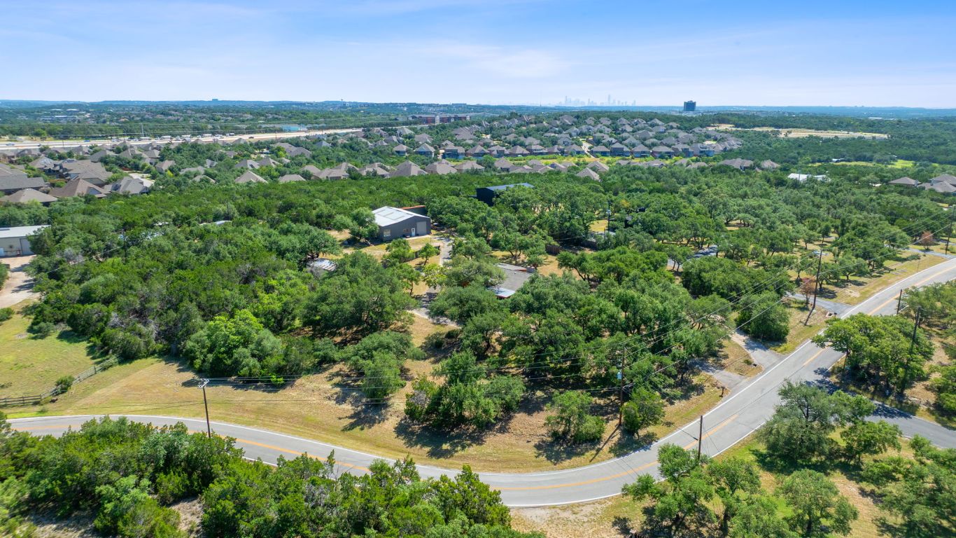 8705 South View Road Austin, TX 78737 - Photo 38 of 39 an aerial view of green landscape with trees houses and mountain view
