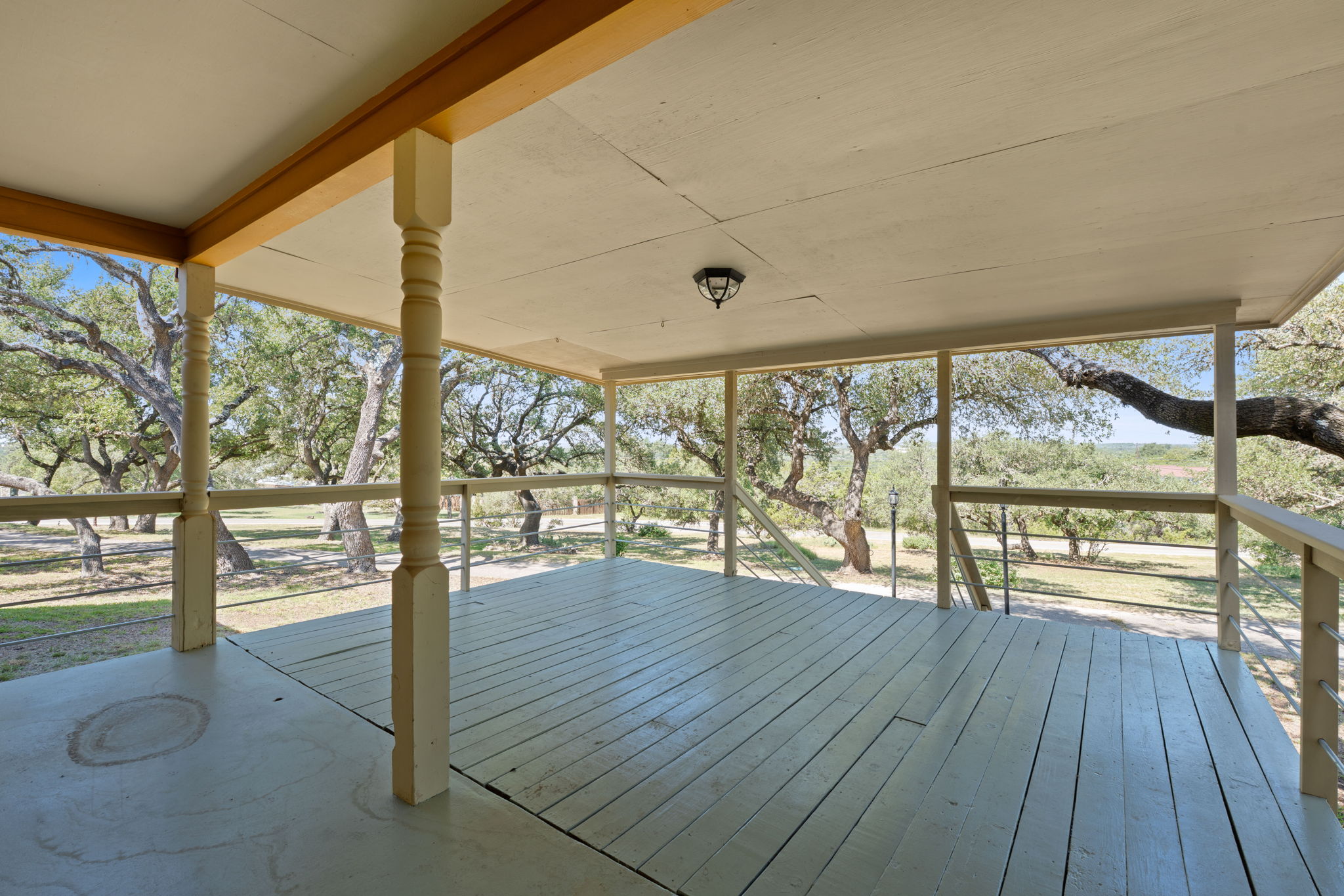8705 South View Road Austin, TX 78737 - Photo 5 of 39 Expansive Covered Porch Perfect for Outdoor Living and Entertaining. Enjoy panoramic views of the property while relaxing in the shade of this thoughtfully designed outdoor space.