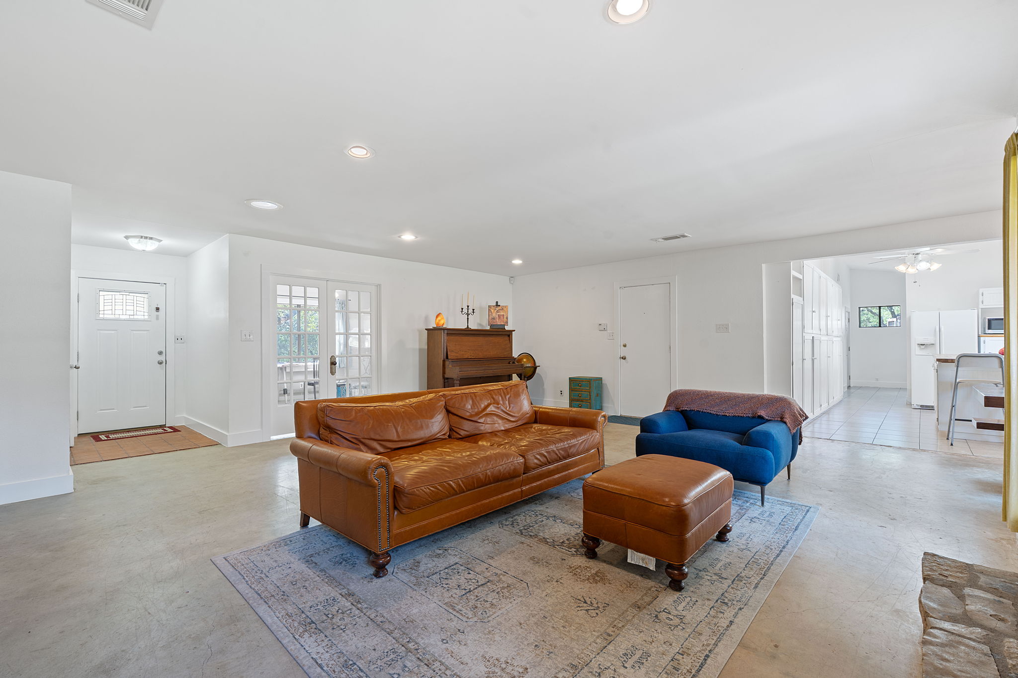 8705 South View Road Austin, TX 78737 - Photo 39 of 39 Spacious Open Floor Plan with Seamless Flow Between Living Spaces. Bright white walls, ample natural light, and polished concrete floors create a modern yet warm ambiance.