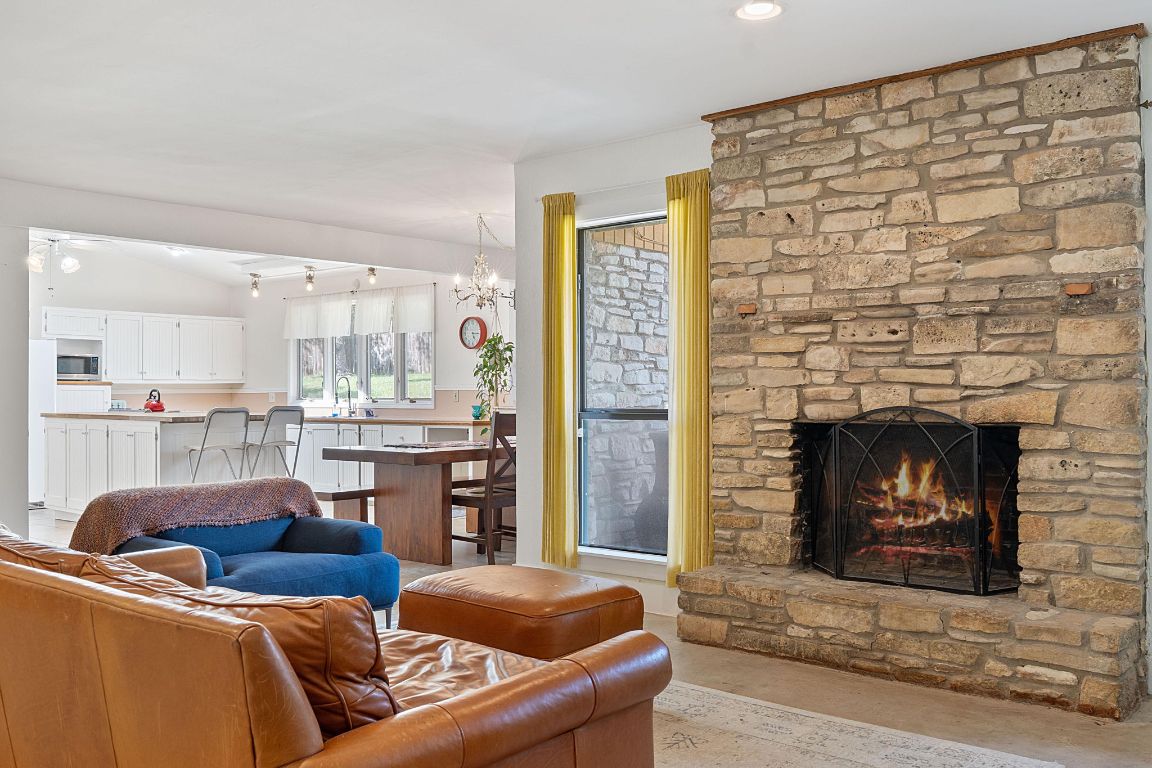 8705 South View Road Austin, TX 78737 - Photo 8 of 39 a living room with furniture and a fireplace