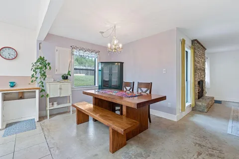 a view of a room with furniture and a chandelier