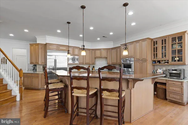 a view of a dining room with furniture wooden floor and a chandelier