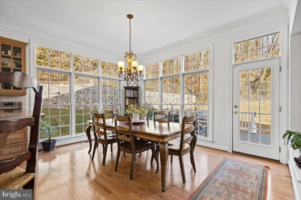 a dining room with furniture a fireplace and a flat screen tv