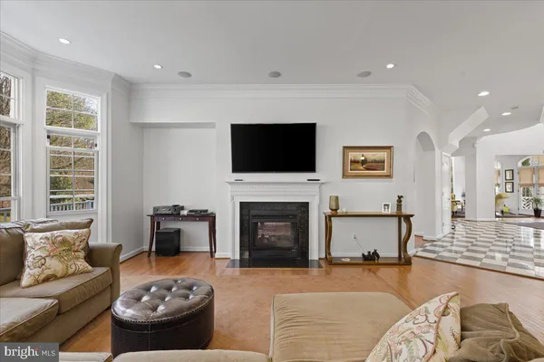 a view of a hallway with wooden floor and stairs