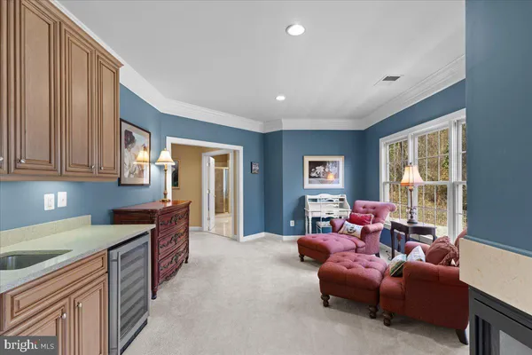 a spacious bedroom with a bed and a lamp on table