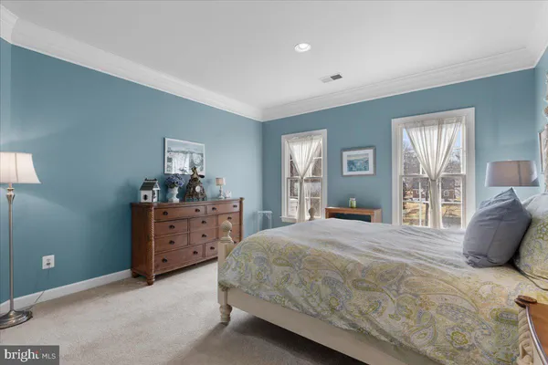 a front view of a house with a small yard and wooden fence