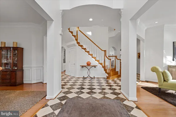 a dining room with furniture a chandelier and wooden floor