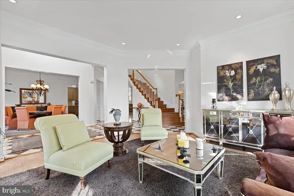a dining room with furniture a chandelier and window