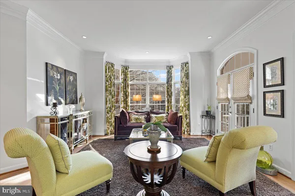 a kitchen with stainless steel appliances kitchen island granite countertop a dining table chairs and sink