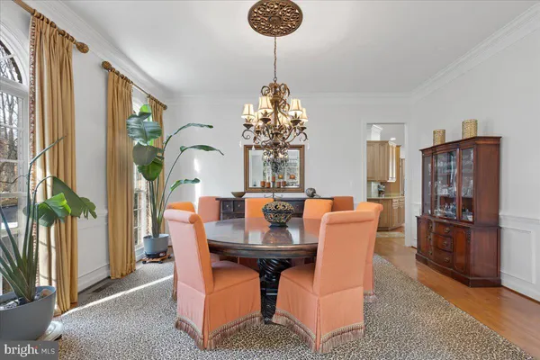 a kitchen with stainless steel appliances kitchen island granite countertop a stove a sink and white cabinets