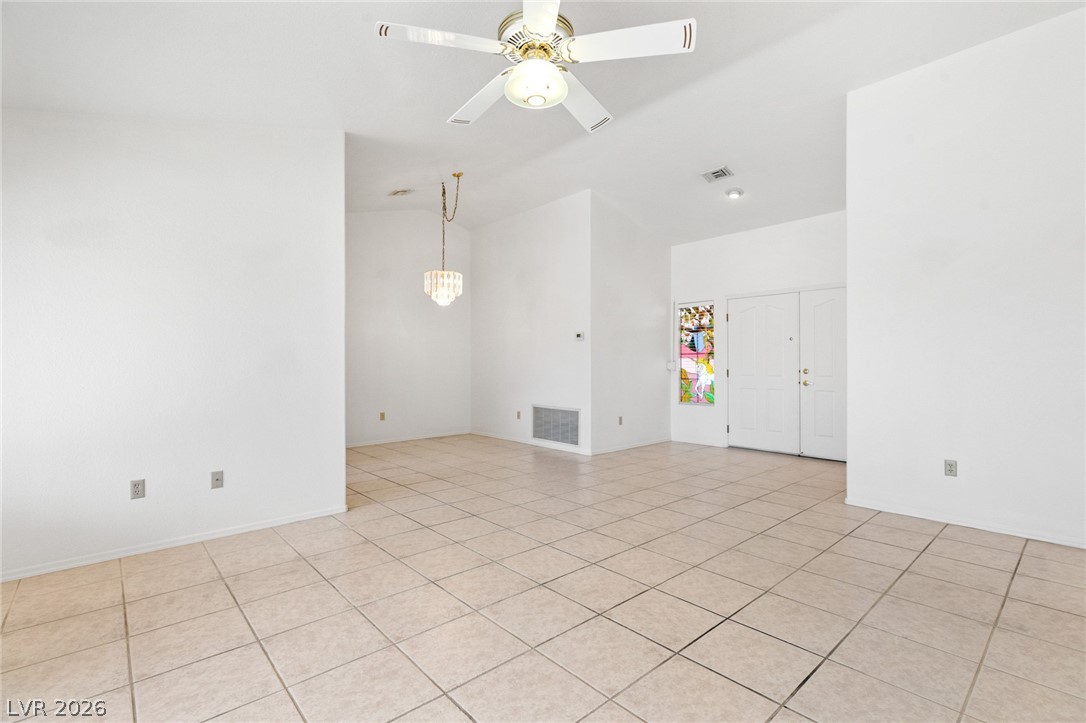 9433 Quail Ridge Drive Las Vegas, NV 89134 - Photo 12 of 25 This bright and airy living space features vaulted ceilings and tiled flooring, creating an inviting atmosphere.