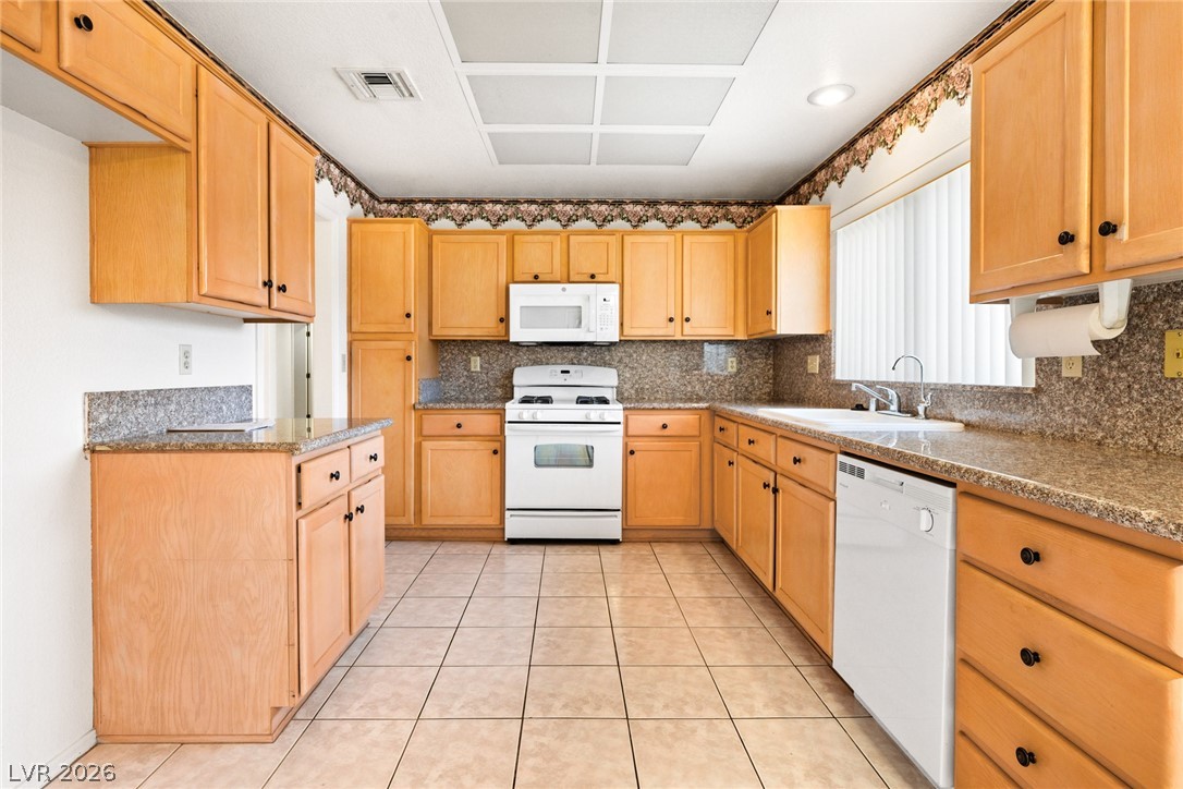 9433 Quail Ridge Drive Las Vegas, NV 89134 - Photo 15 of 25 This spacious kitchen offers ample cabinet and counter space, ideal for any culinary endeavor.