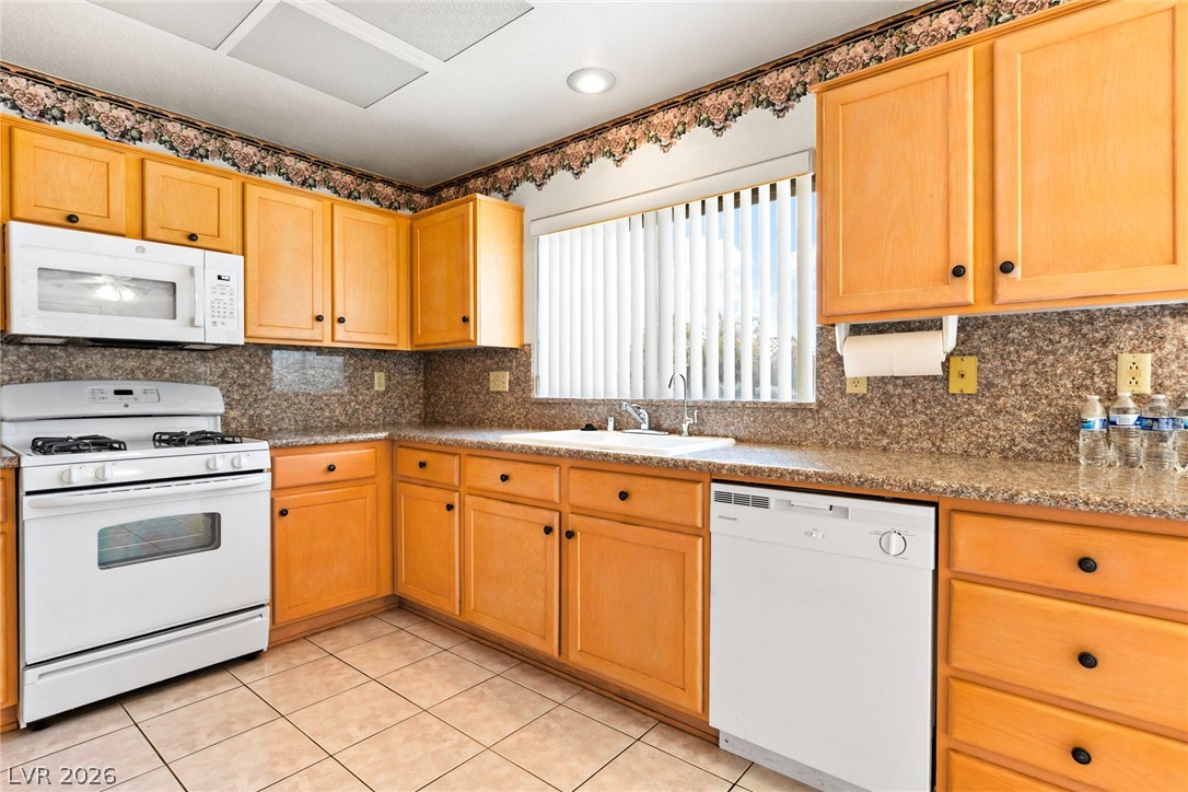 9433 Quail Ridge Drive Las Vegas, NV 89134 - Photo 17 of 25 This functional kitchen features ample cabinetry and integrated appliances for comfortable meal preparation.