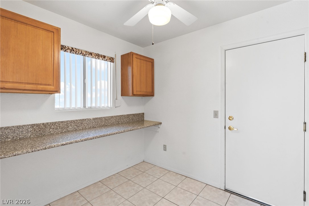 9433 Quail Ridge Drive Las Vegas, NV 89134 - Photo 18 of 25 This bright utility room features practical counter space and easy outdoor access, perfect for daily tasks.