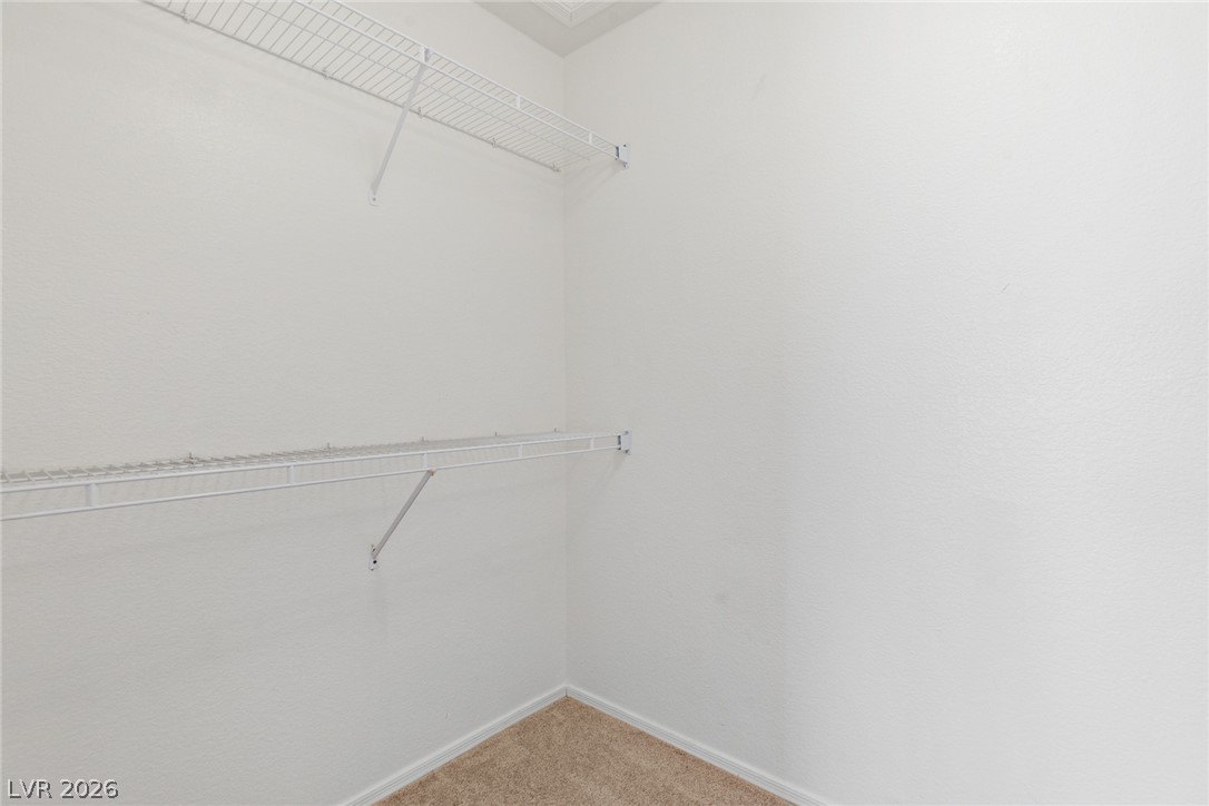 9433 Quail Ridge Drive Las Vegas, NV 89134 - Photo 24 of 25 This spacious walk-in closet features ample shelving for organized storage.