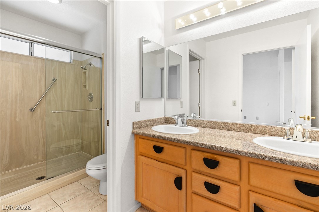 9433 Quail Ridge Drive Las Vegas, NV 89134 - Photo 25 of 25 This bright bathroom offers dual sinks, a spacious vanity, and a shower.